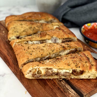 Stuffed Focaccia: Simple, Italian inspired meal has all the flavors of your favorite pizza. Golden, warm, yeasty bread stuffed with plant based savory sausage and cheese, served with a side of a robust sweet marinara sauce makes easy, fun party dinner.