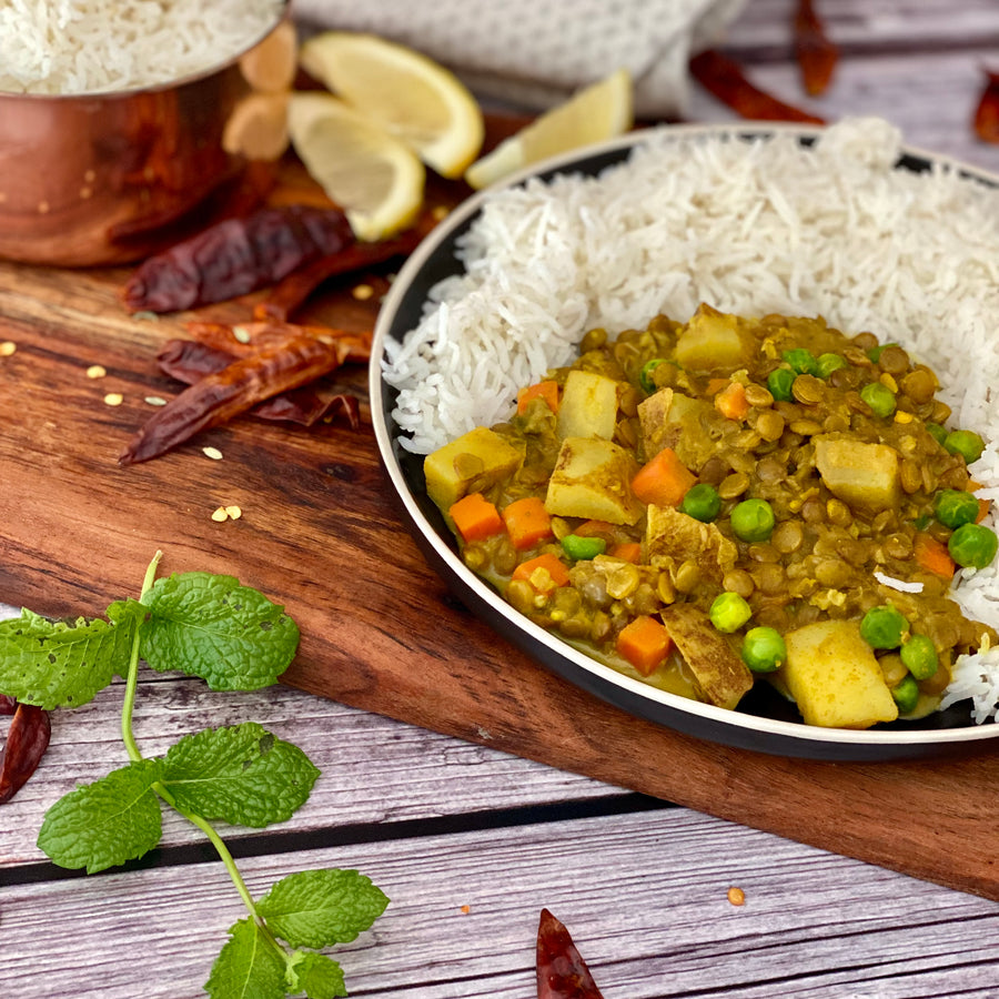 Burmese Lentil Potato Curry: Colorful warmly spiced aromatic bowl of goodness with. Carrots, potatoes, lentils, and peas simmered in luxuriously rich coconut milk curry sauce served over bowl of hot basmati rice.